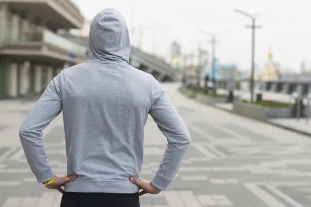 Athletes in hoodies turn their backs on us