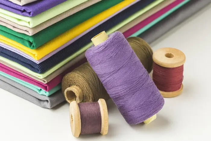 Stack of fabric with spools of thread