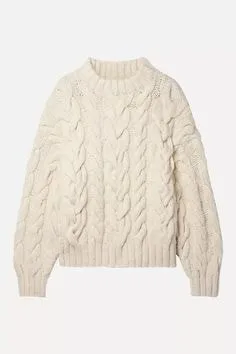 Cream chunky cable knit sweater with a high neckline, showcasing cozy sweater styles for winter fashion.