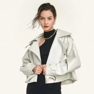 Stylish woman in a white cropped jacket and black outfit, designed by a high-end women’s clothing manufacturer.