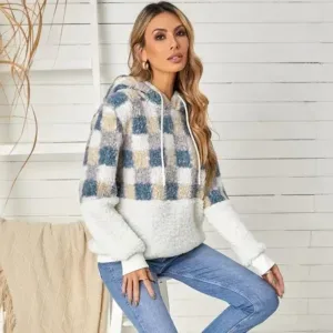 Female model in a cozy plaid hoodie paired with jeans, styled by a casual clothing manufacturer.